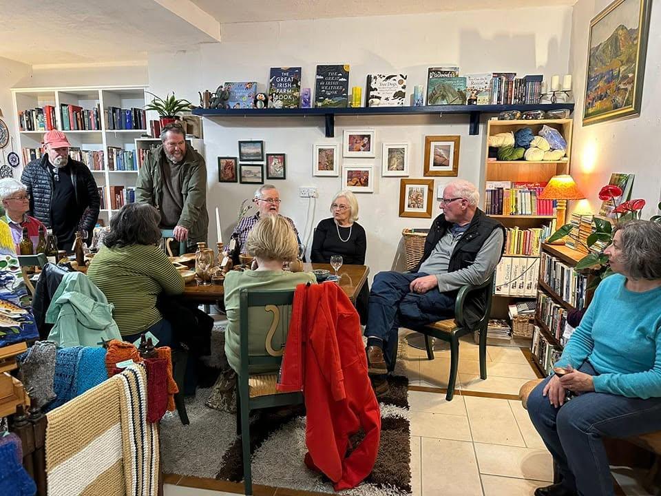 Friends and neighbours gathered around the big table at Sneem Book Shop, surrounded by bookshelves and baskets of knitting wool
