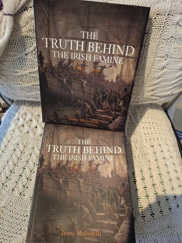 Two copies of The Truth Behind the Irish Famine by Jerry Mulvihill displayed on a hand-knitted blanket at Sneem Book Shop